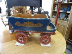 A painted vintage Gypsy style child's pull along wagon having long handle, body length 65cms, with 2