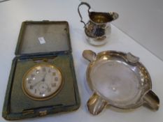 A silver ashtray hallmarked Sheffield 1925 Walker and Hall, with a small silver gilt jug, hallmarked