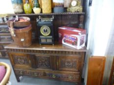 An antique carved oak sideboard having raised panel back on turned supports, 137cms