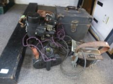 A Bell and Howell Automatic cine camera, a Bell and Howell Films ' 57 projector, screen and