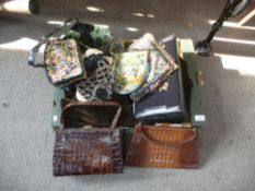 A tray of old handbags, some crocodile and a velvet suit