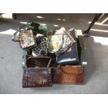 A tray of old handbags, some crocodile and a velvet suit