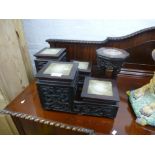 A pair of Chinese hardwood stands, having carved decorations and inset marble tops, and one