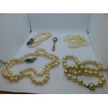 Two strings of pearls with yellow metal clasps and simulated example etc