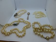 Two strings of pearls with yellow metal clasps and simulated example etc