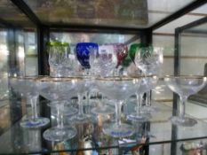 Four coloured crystal glasses with three similar cut glasses, along with 6 Babycham glasses