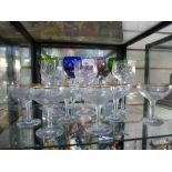 Four coloured crystal glasses with three similar cut glasses, along with 6 Babycham glasses