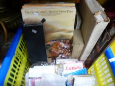 A box of music related items to include guitar strings, stand, LP, books, etc