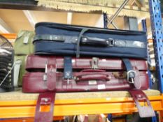 Three suitcases, two being red and one being blue