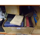 A box of old books mostly comprising of vintage bibles and a display case