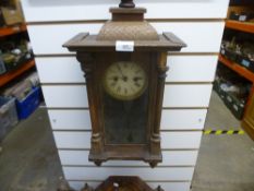 Two wooden cased pendulum clocks and two spelt figures