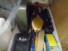 A box of vintage items to include cameras, brushes and combs, etc, and a box of mixed glass and