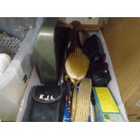 A box of vintage items to include cameras, brushes and combs, etc, and a box of mixed glass and
