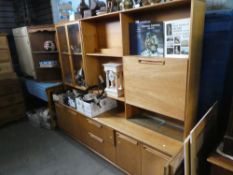 Mid century teak wall unit with glazed bookcase, open bookcase and drop down desk above drawers