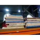 A shelf of crafting tools and hardback books on Dolls Houses