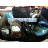 A box of sundry items to include clocks, silver plate, pottery vase, LPs, Le Creuset pots, etc