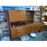 Mid century teak sideboard with glazed door, shelves and dropdown cupboard above 3 drawers and