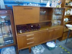 Mid century teak sideboard with glazed door, shelves and dropdown cupboard above 3 drawers and
