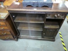 Oak glazed bookcase with drawer and cup