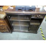 Oak glazed bookcase with drawer and cup