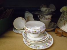 An Aynsley April Rose design tea set comprising six tea cups and saucers, cake plates, sugar bowl,