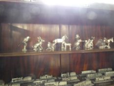 Two shelves of pewter model trains by Royal Hampshire to include The King George V limited