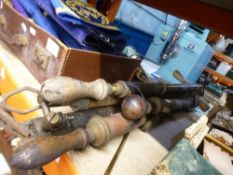 A bundle of vintage garden sprayers and two brass bellows