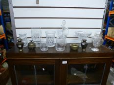 A quantity of cut glass items to include a bon bon dish, vases, decanter and four brass ornaments