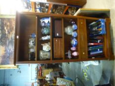 A dark wood bookcase with a central drawer