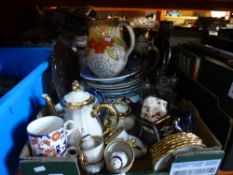 A box of china containing teapots, plates and jugs of various patterns