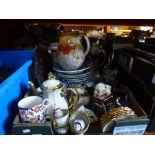 A box of china containing teapots, plates and jugs of various patterns