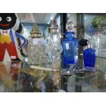 A selection of cut glass bottles of which two are blue perfume bottles and a small quantity of