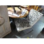 Contemporary lounge chair upholstered in Zebra print, on chrome supports