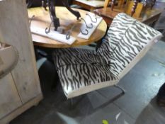 Contemporary lounge chair upholstered in Zebra print, on chrome supports