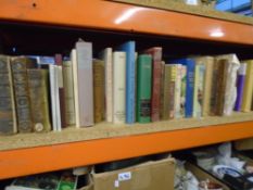 A shelf of hardback books, some being leather bound