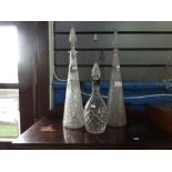 Pair of tall crystal decanters and silver coloured crystal example