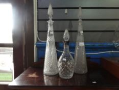 Pair of tall crystal decanters and silver coloured crystal example