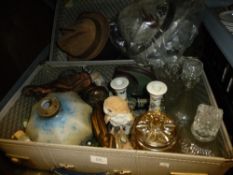 A vintage suitcase containing mixed items to include Mei-lin candlesticks, Royal Doulton animal