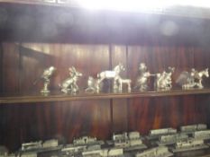 Shelf of silvered pewter model animals including horse, rabbits, birds, etc