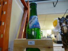 A wooden peanuts crate and large glass Babycham money bottle