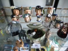 A quantity of Royal Doulton Toby jugs, a Wedgwood lidded dish, Caithness paperweights, etc