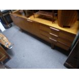 A vintage teak sideboard having three drawers, length 213 cms