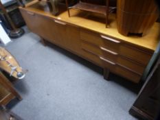 A vintage teak sideboard having three drawers, length 213 cms