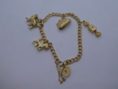 9ct yellow gold charm bracelet with heartshaped padlock, marked 375, hung with 4 charms, weight