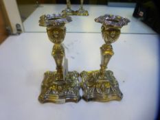 Pair of Sheffield silver table candlesticks decorated in the classical style, shaped square bases,