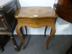 A 19th century French rosewood sewing table, having inlaid lid with brass edging on cabriiole