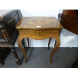 A 19th century French rosewood sewing table, having inlaid lid with brass edging on cabriiole