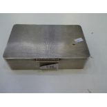 A heavy silver cigarette box having an engine turned design exterior and a gilted interior with