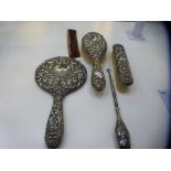 A silver dressing table set of five items of two brushes, comb, mirror and a silver handled button