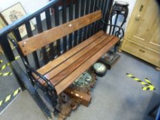 A Victorian style metal and wooden slatted bench having black painted ends, 167cms